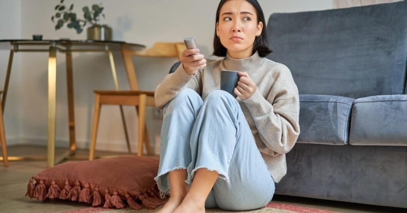 portrait-young-woman-with-remote-watching-tv-switching-chanels-television-sitting-floor-nea_1258-139038
