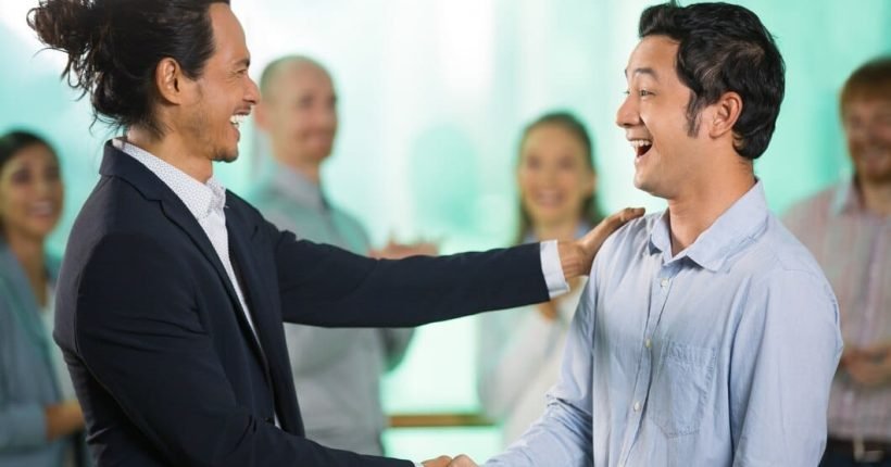 smiling-asian-business-man-greeting-male-partner_1262-1119